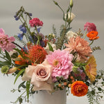 Load image into Gallery viewer, Colorful flower arrangement in a white vase on a light gray background